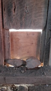 Rocks blocking chicken coop door for winter safety