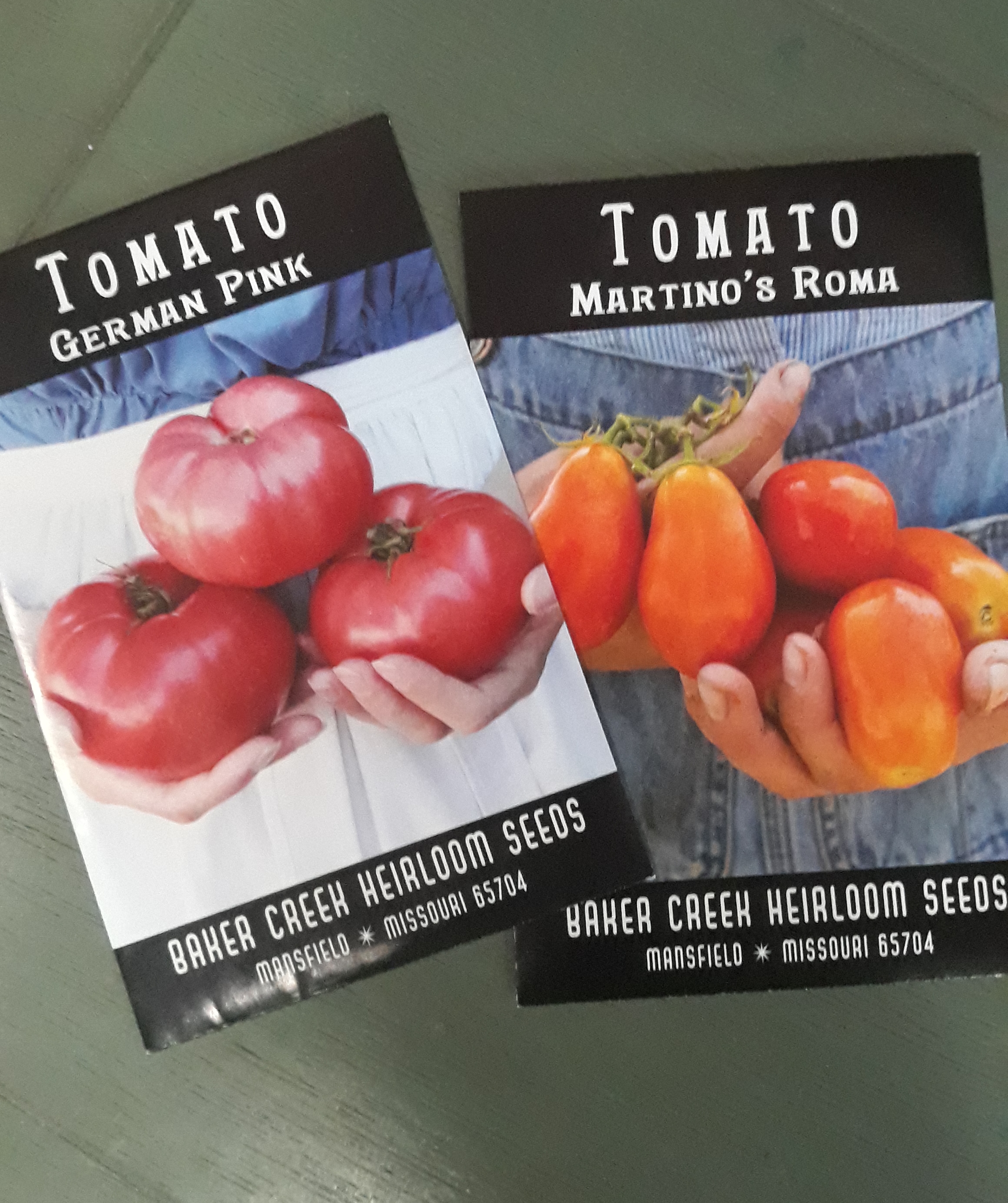 Two seed packets for german pink and Martino's Roma tomatoes from Baker Creek
