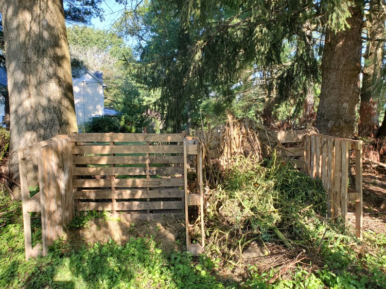 five wood pallets nailed together in the shape of the letter M