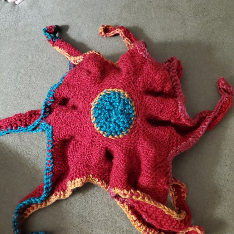underside of knitted red octopus
