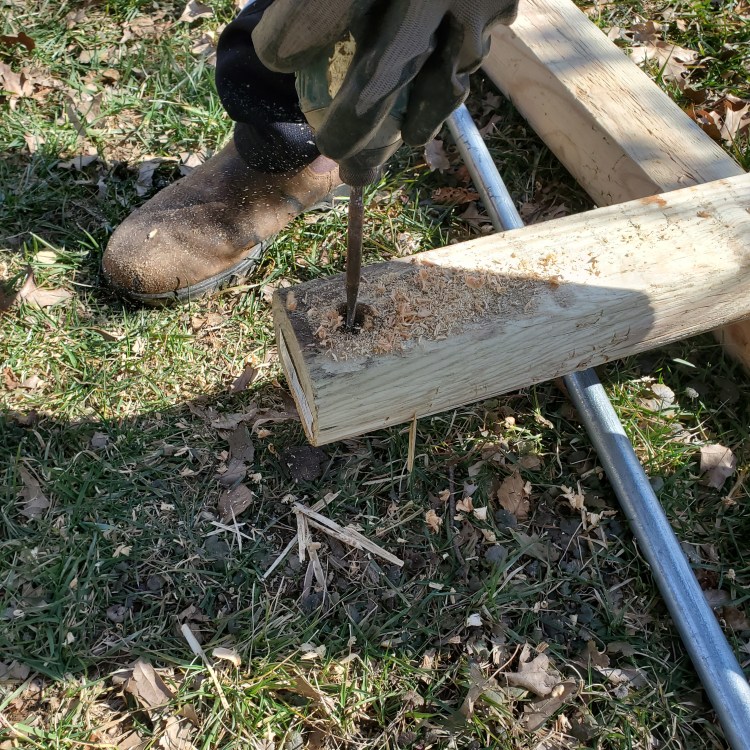 First hole drilled at the top of each post for the galvanized tubing to pass through
