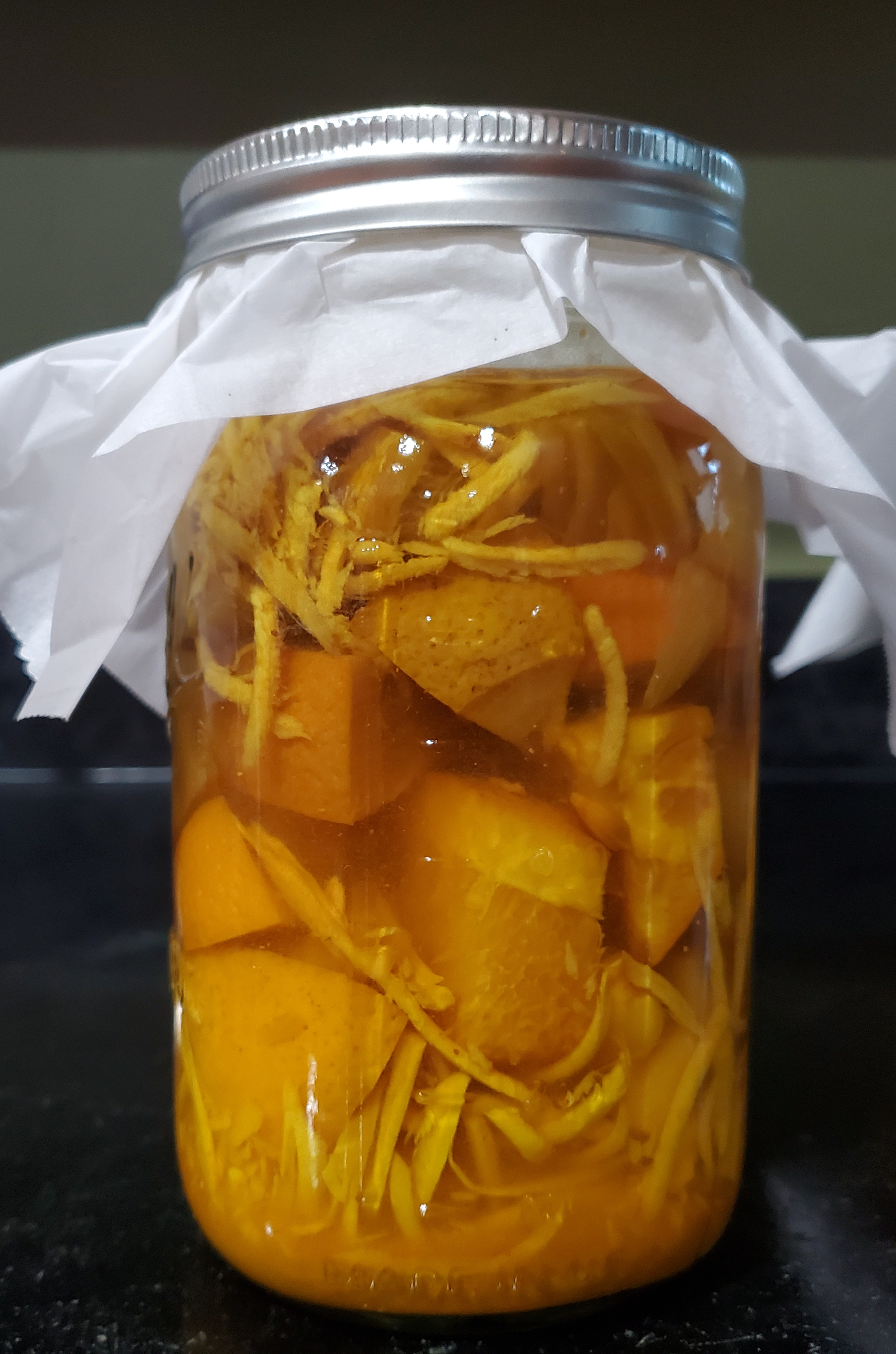 a quart mason jar brewing with fire cider