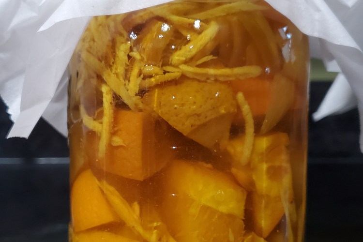 a quart mason jar brewing with fire cider