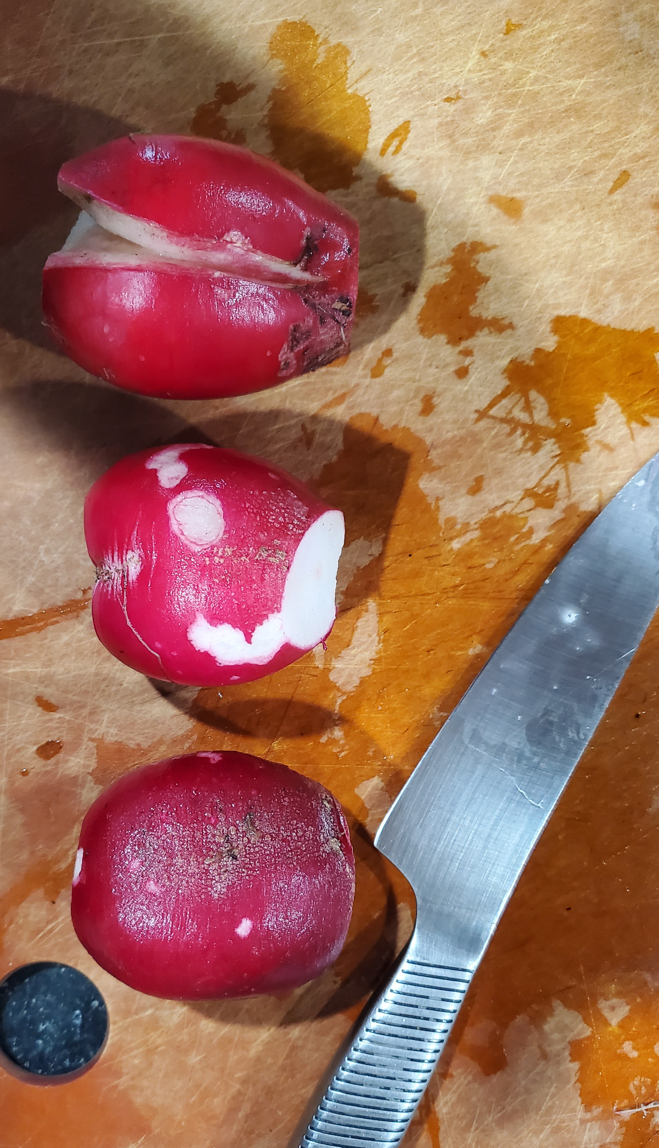 three cleaned radishes ready for peeling