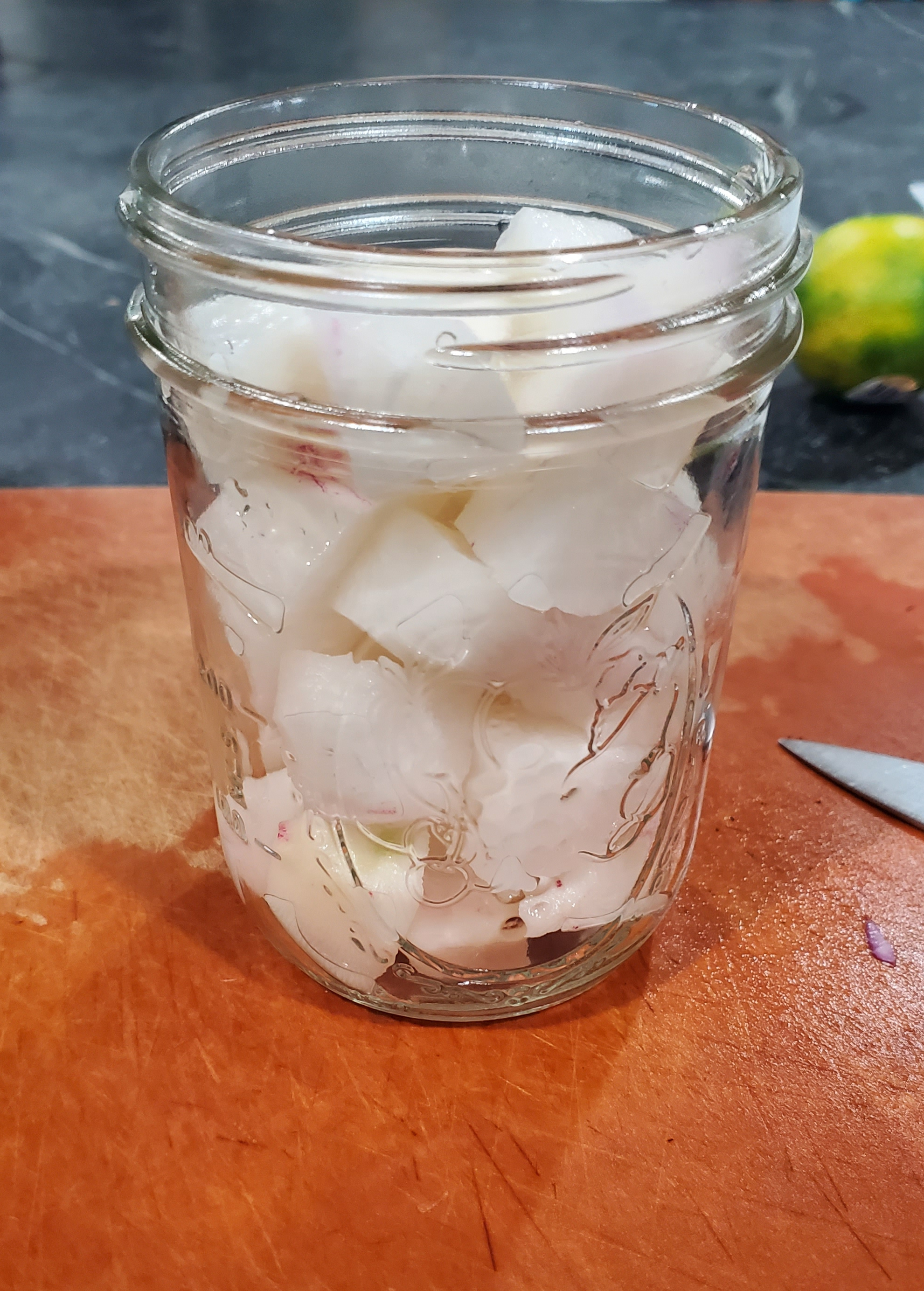 chopped radish in canning jar for pickling